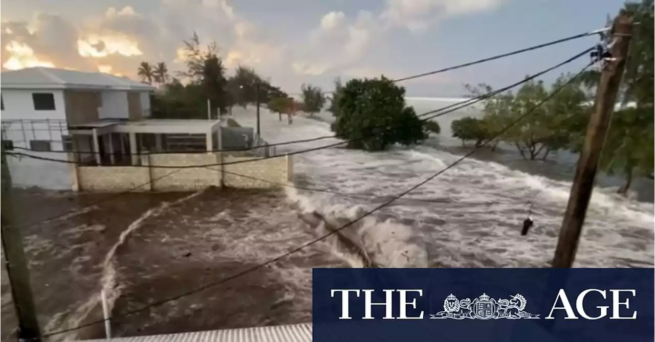 Waves crash into Tonga homes as tsunami warnings sound across the Pacific