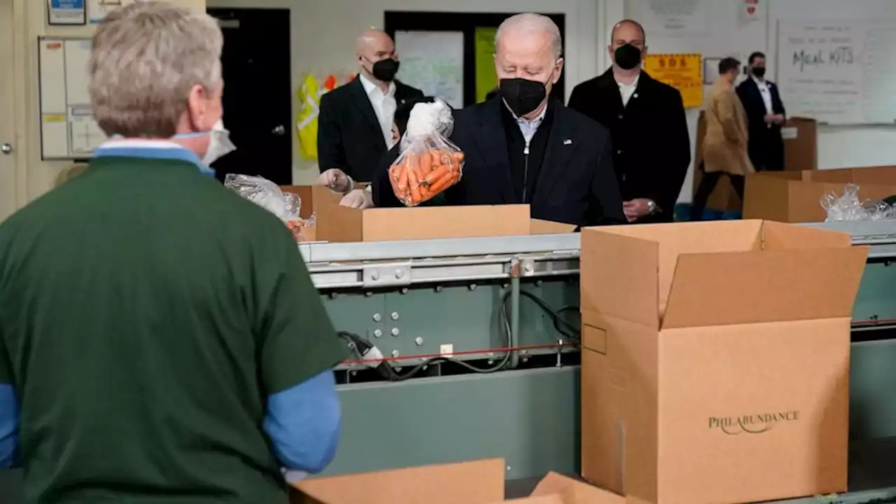 Bidens pack carrots, apples into boxes during food bank stop