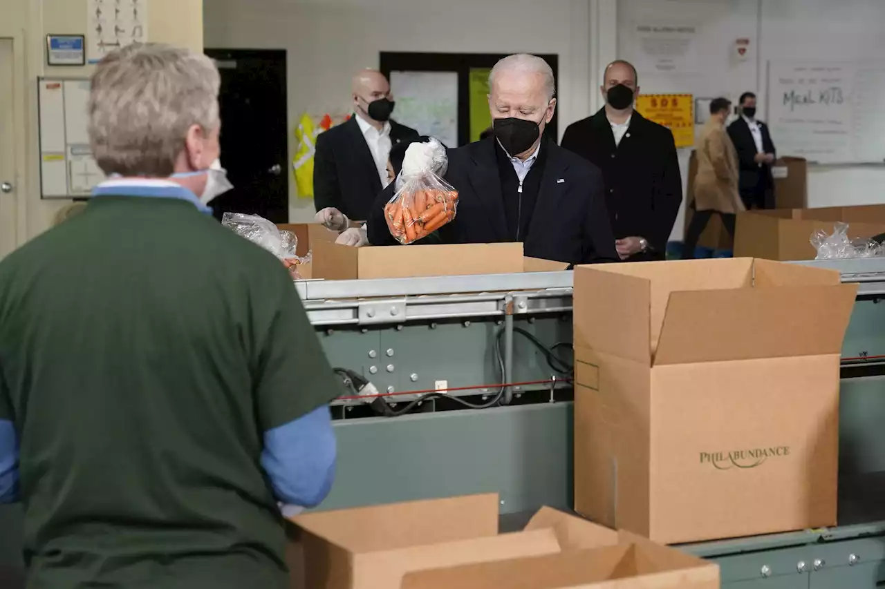 Bidens pack carrots, apples into boxes during food bank stop | AP News