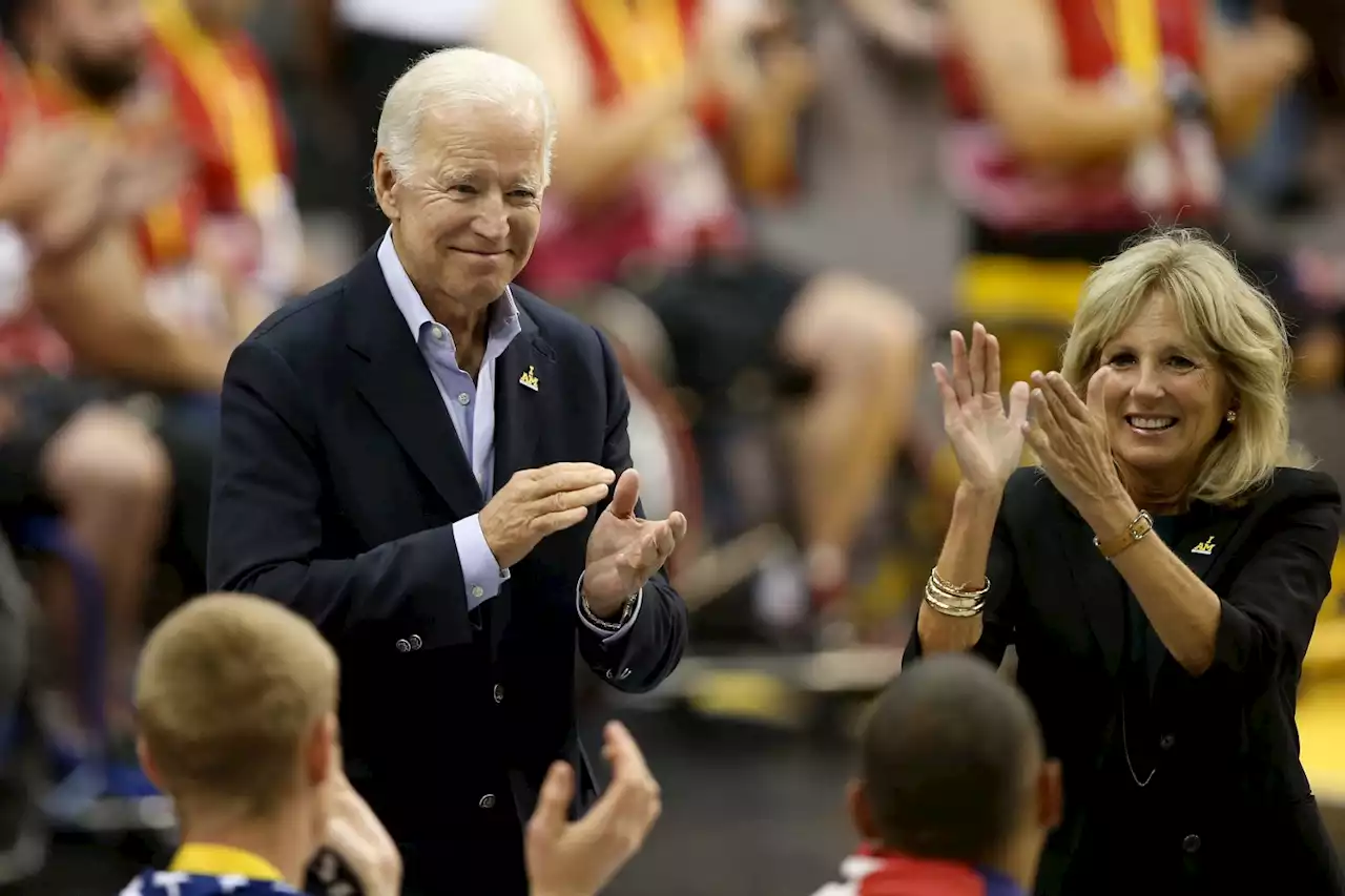 Bidens Pack Carrots, Apples Into Boxes During Food Bank Stop