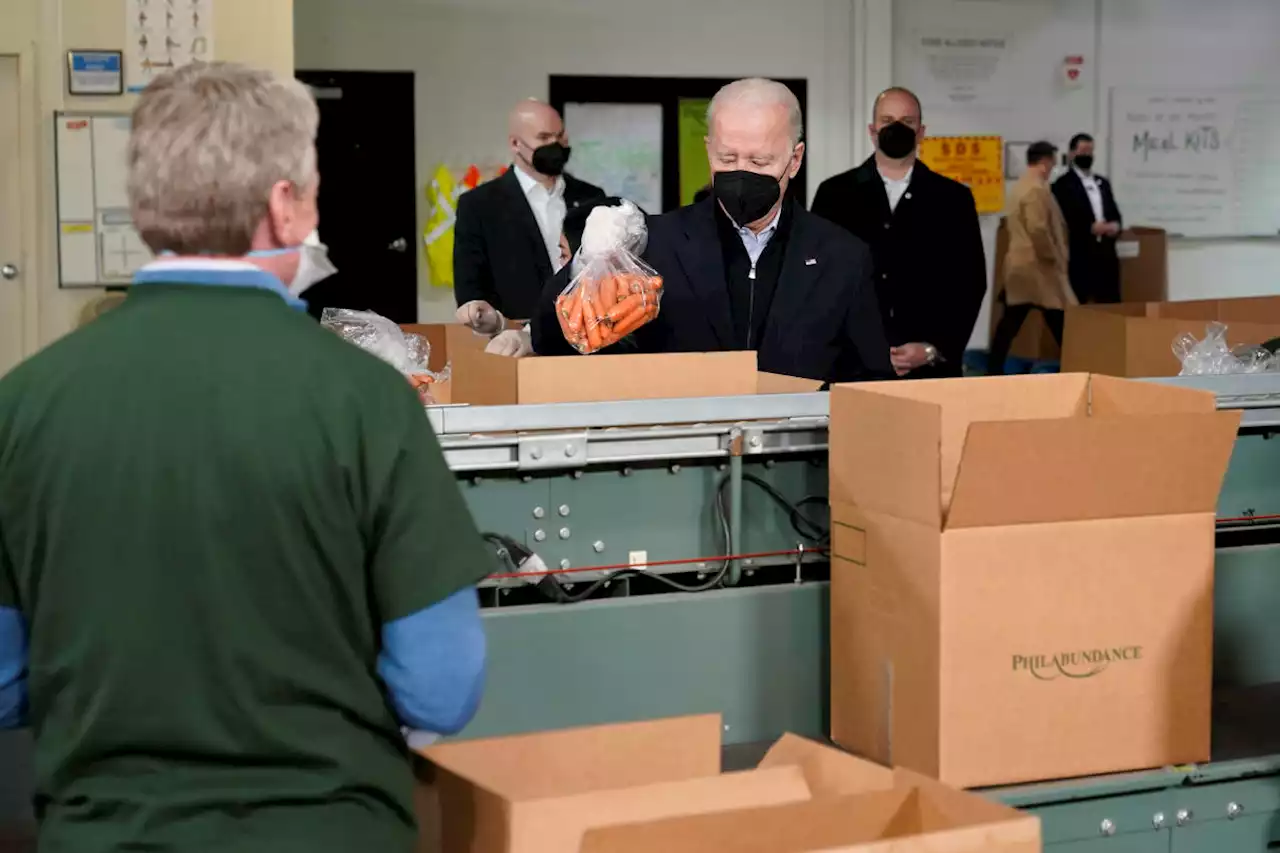 Bidens pack carrots, apples into boxes during food bank stop