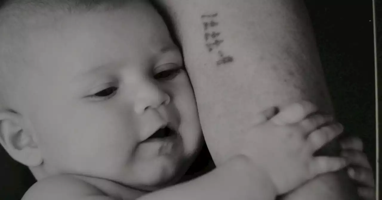 See the viral photo of a Holocaust survivor holding great-grandchild