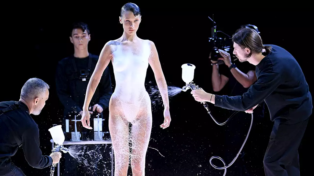 Bella Hadid Walks Runway Topless, Gets Dress Spray-Painted On At Fashion Show