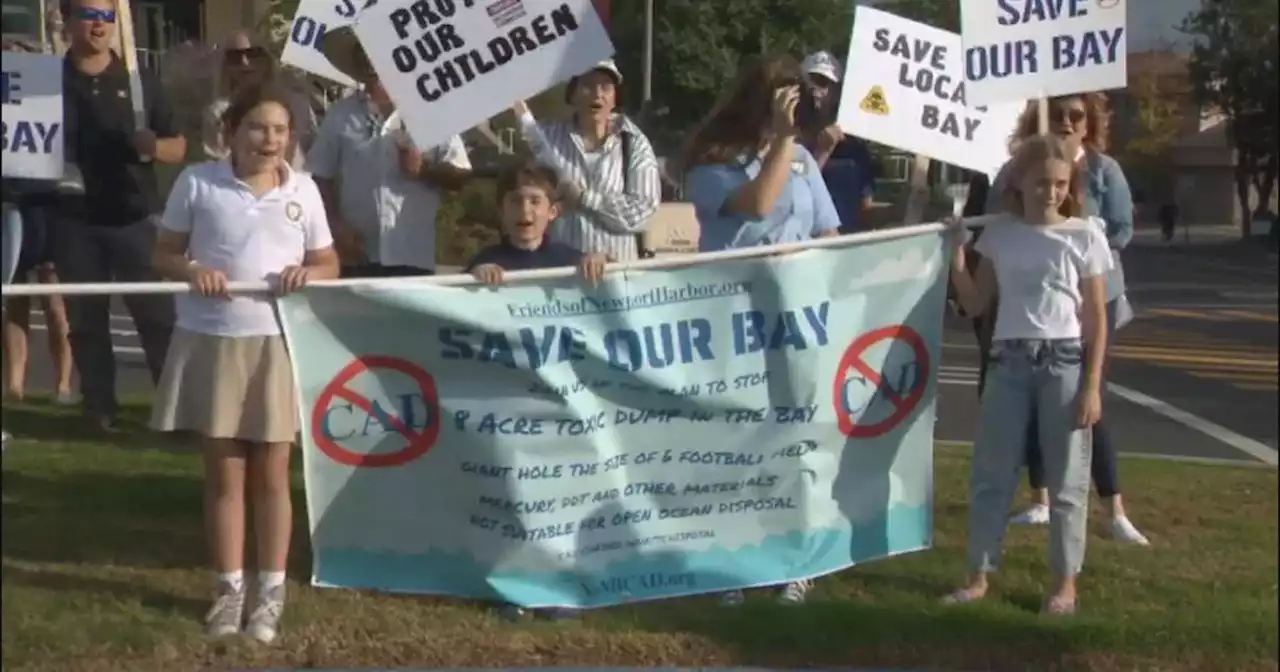 Activists march against potential dredging project in Newport Harbor