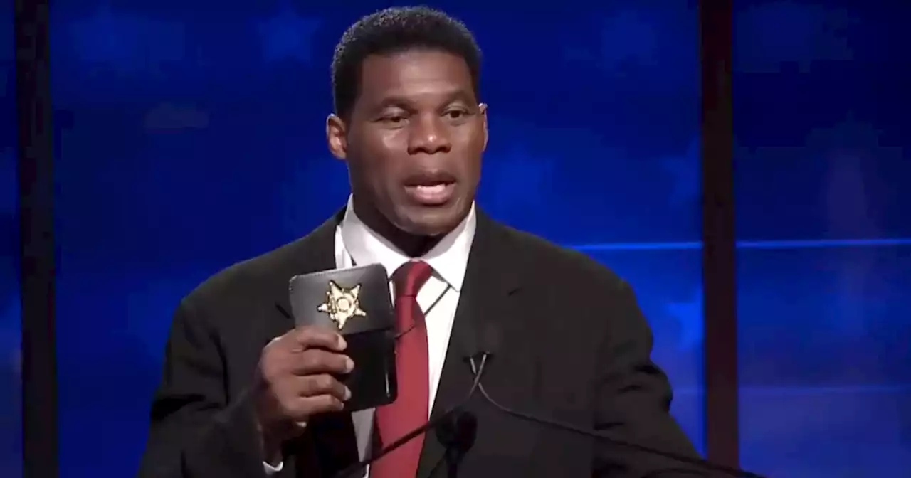 WATCH: Herschel Walker flashes fake badge onstage during debate with Warnock