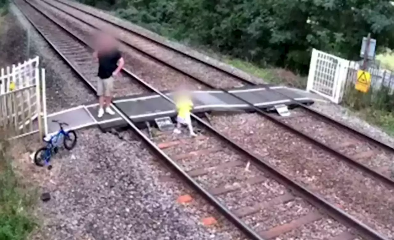 ‘Frightening’ footage shows boy playing on live train line while dozy dad is on phone