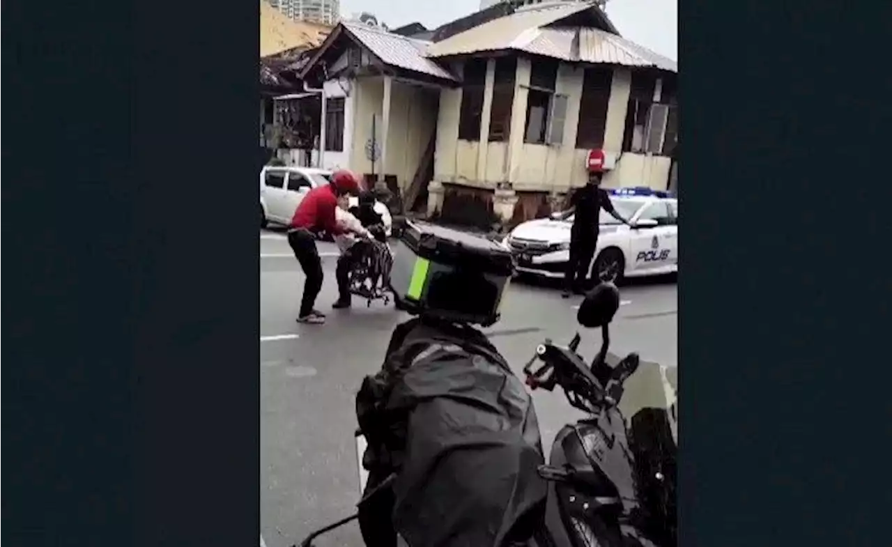 Cop's heartwarming gesture carrying elderly woman across street earns praise