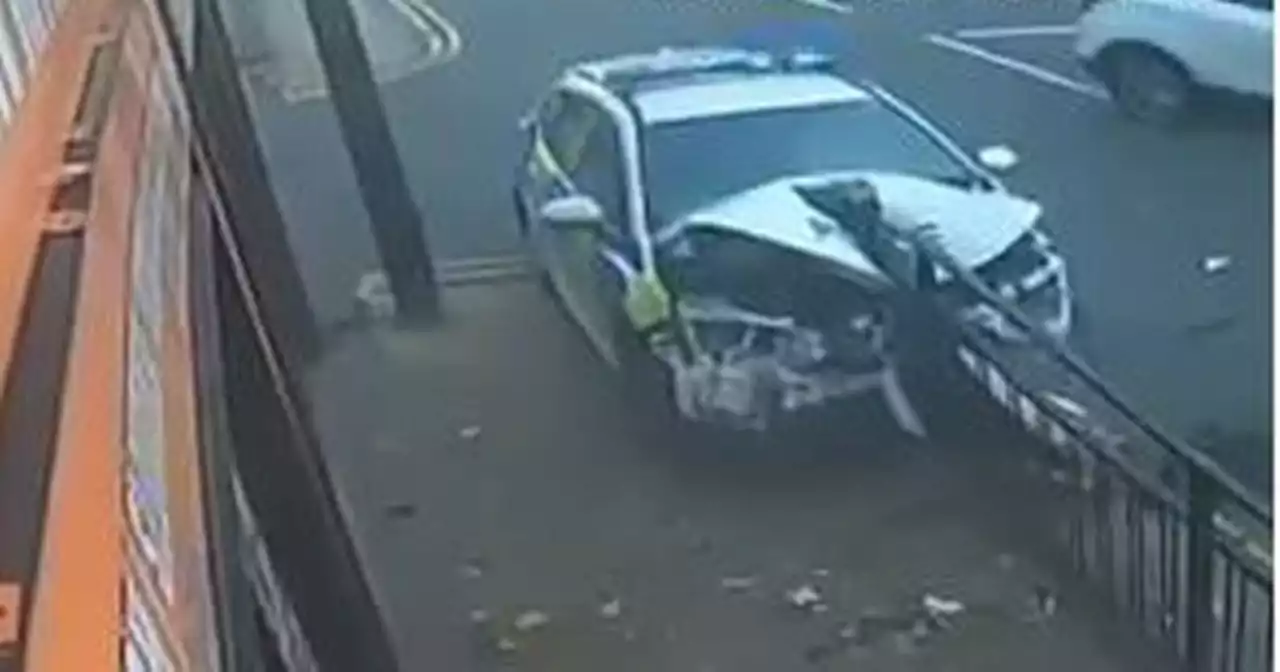 CCTV captures terrifying moment police car smashes into metal barrier