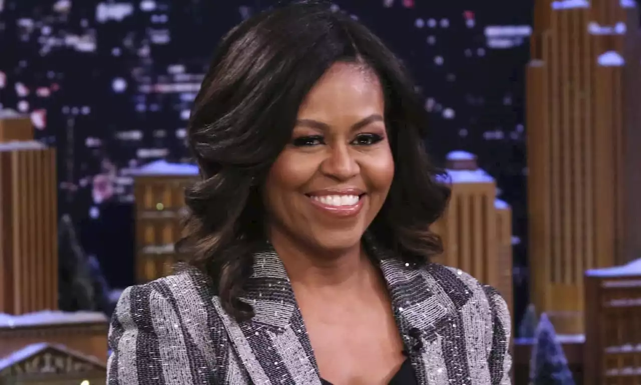 Michelle Obama looks as chic as ever in a sleek satin black suit