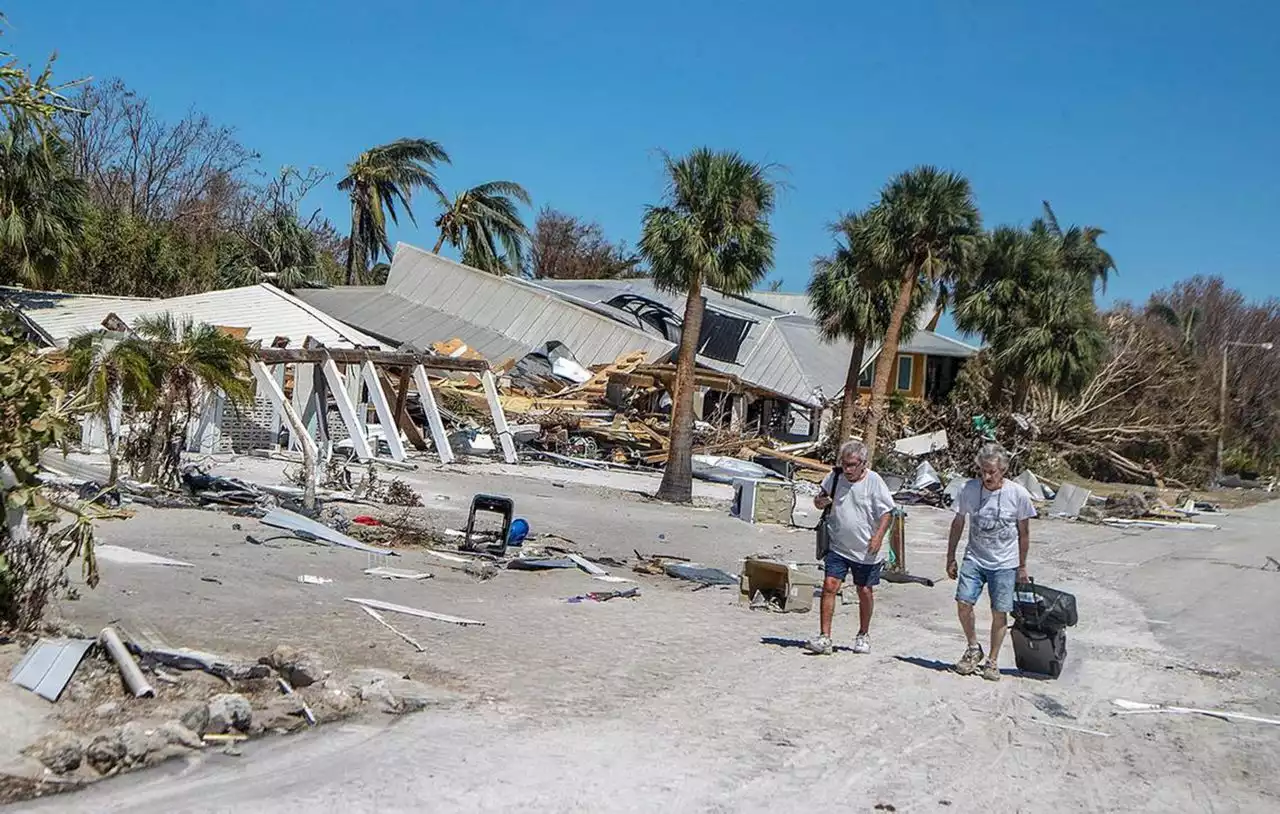 Hurricane Ian survivors leave Fort Myers Beach on foot: ‘We are tired, dirty and hungry’