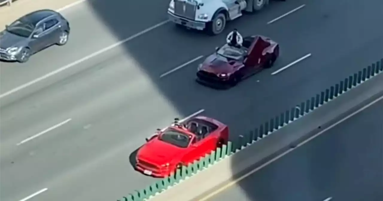 Video shows people hanging out of convertibles to film a music video on the Gardiner