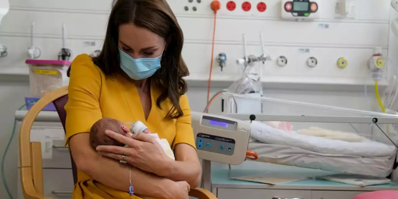 The Princess of Wales sweetly cradles a baby while visiting a hospital maternity unit