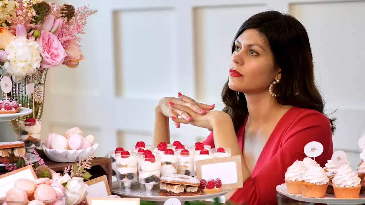 Single Woman Seated At Wedding’s Dessert Table