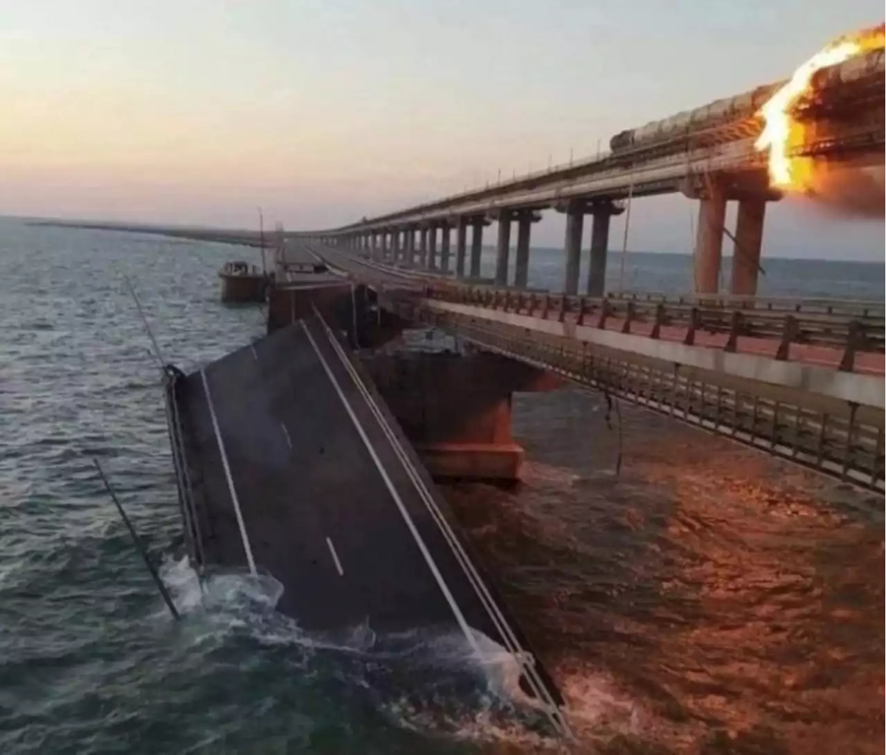 Crimean bridge hit by explosion, erupts in flames as heavy damage seen