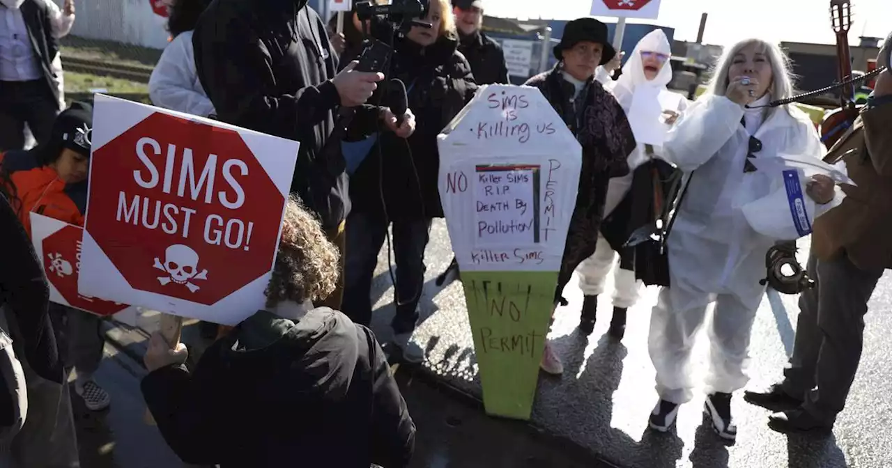 Demonstrators cheer on news public meeting about Sims Metal operating permit postponed until air quality data released from EPA