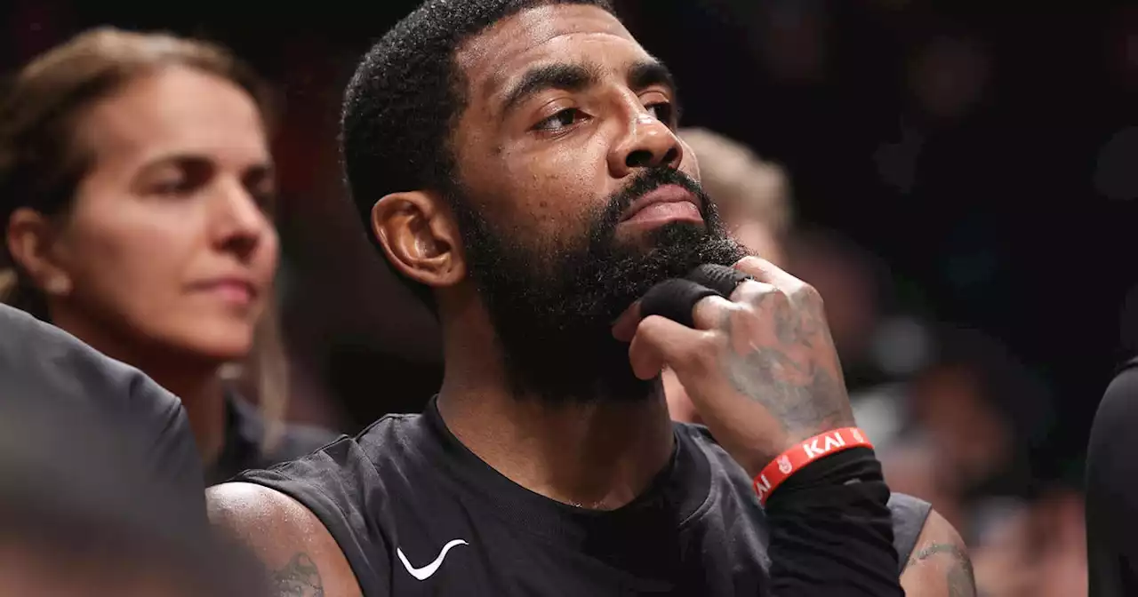 Fans wearing 'Fight Antisemitism' shirts sit courtside after Nets star Kyrie Irving tweet