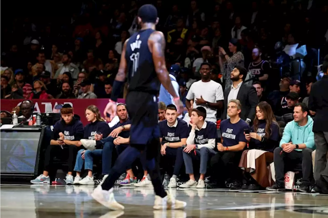 Fans in 'Fight Antisemitism' shirts courtside at Nets game