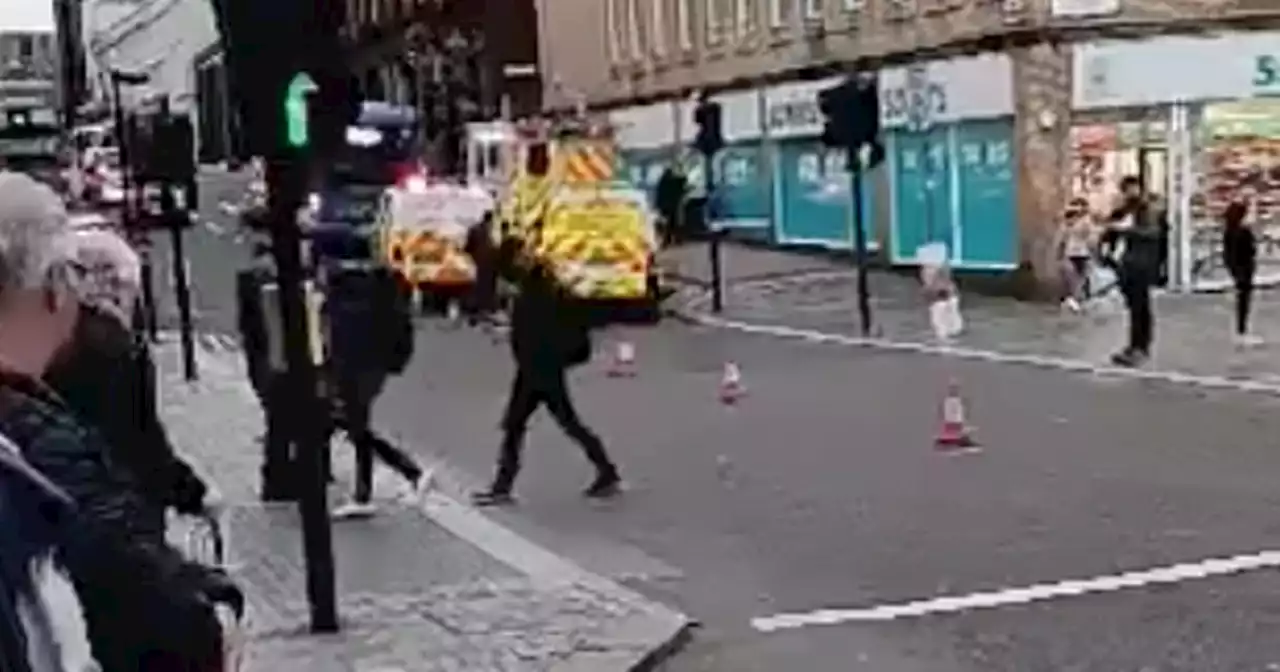 Woman rushed to hospital after being hit by bus on busy city centre street