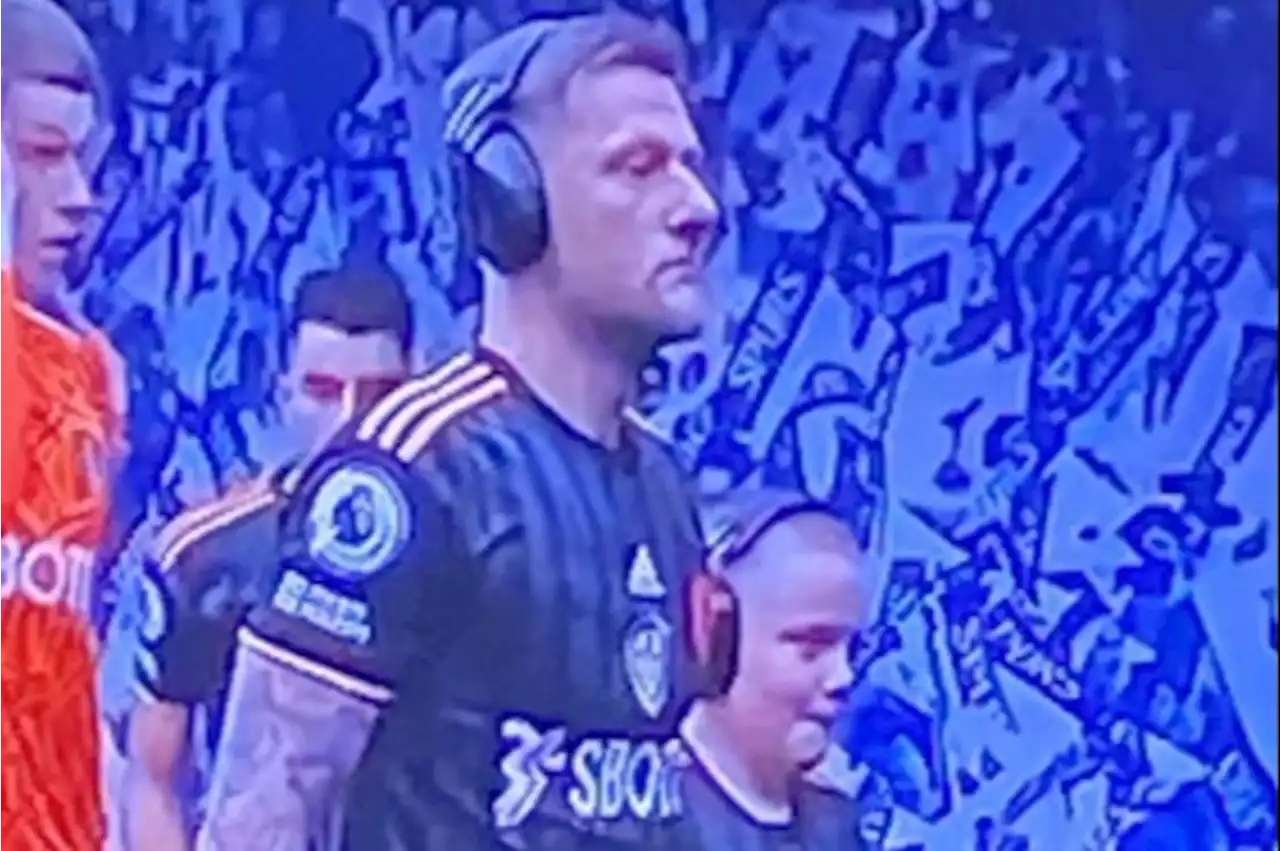 'Our captain' - Cooper wears noise cancelling headphones as he walks out with mascot