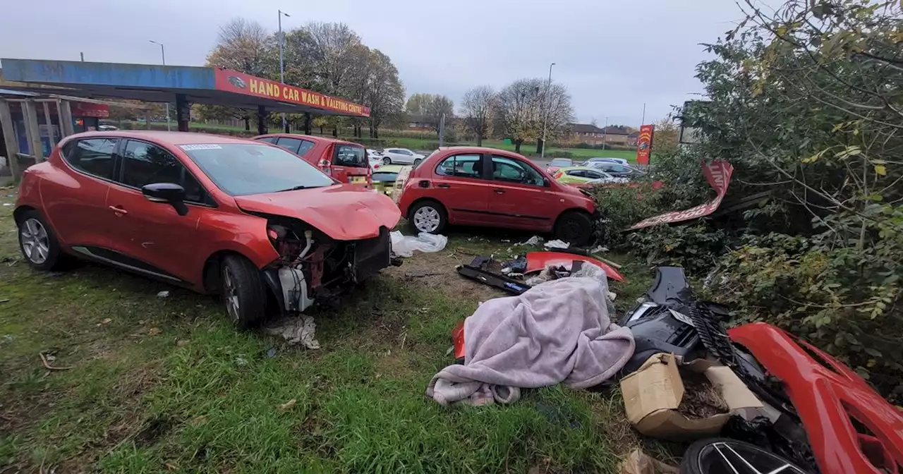 Between crumpled cars on a grass verge strewn with rubbish they found his body