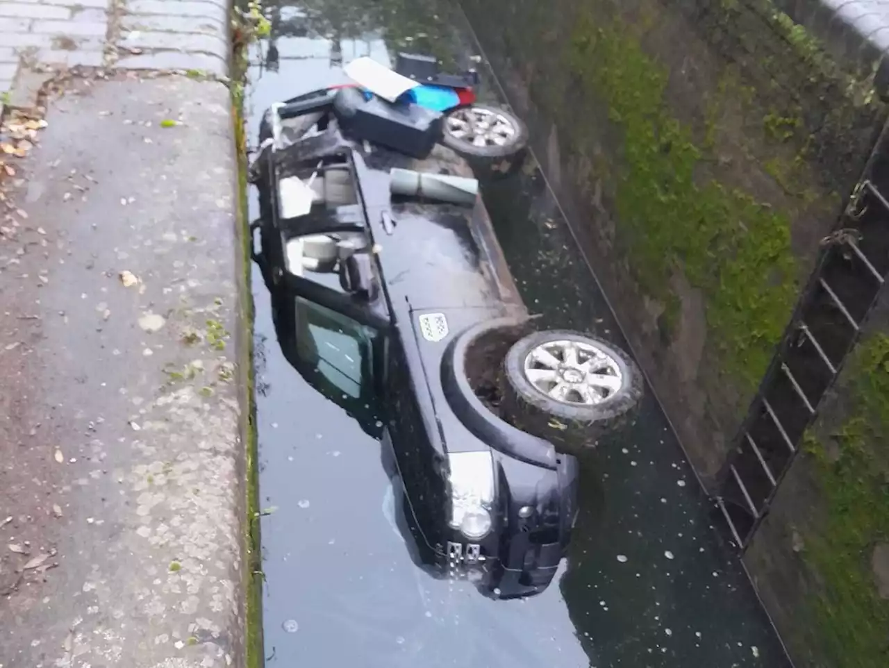 Canal lock is closed off after car falls in