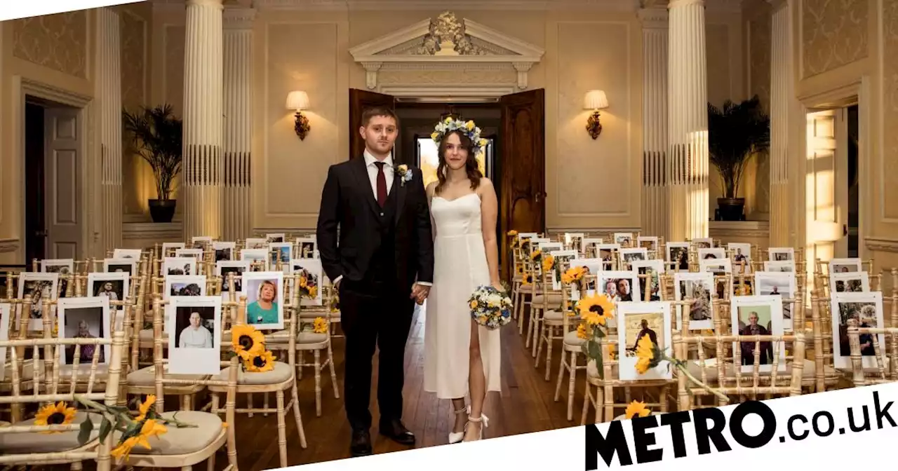 Poignant image of Ukrainian refugees marrying in front of pictures of loved ones