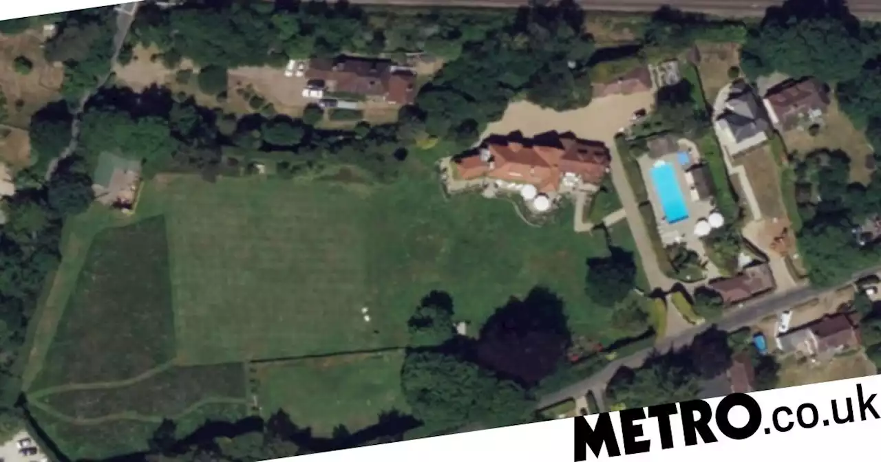 Millionaire neighbours at war over claims one burned down their fence