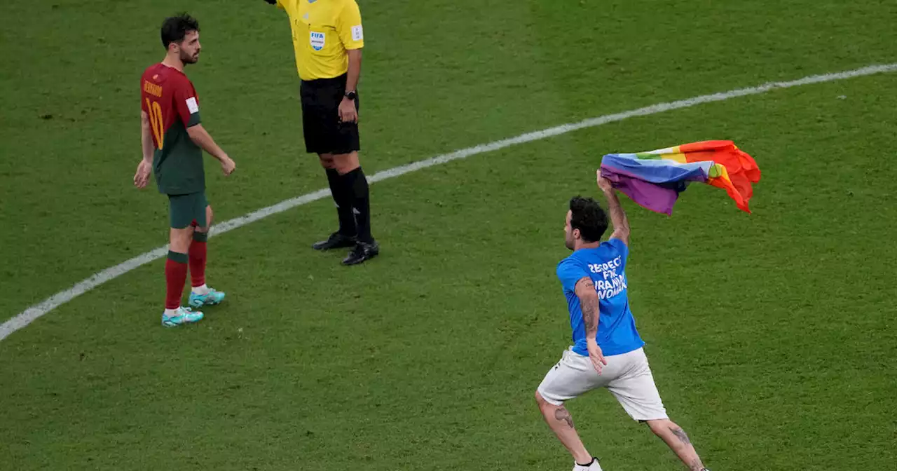 World Cup protester runs onto field with rainbow flag and shirt reading 'Respect for Iranian Woman'