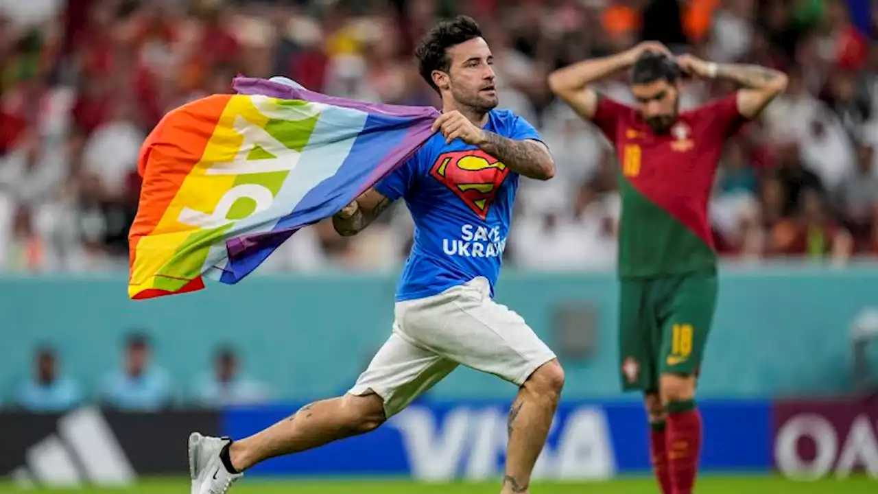 Pitch invader with rainbow flag interrupts World Cup match between Portugal and Uruguay | CNN