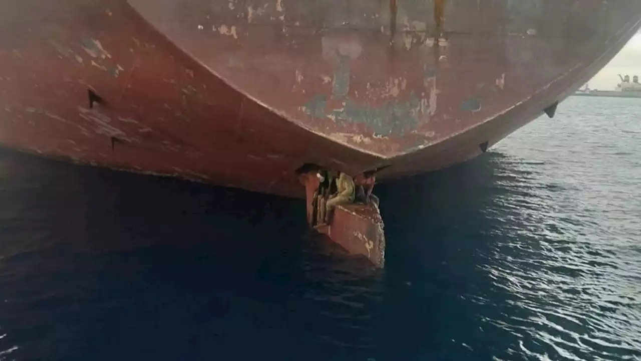 Shocking image shows migrants who risked lives spending 11 days perched on rudder of oil tanker