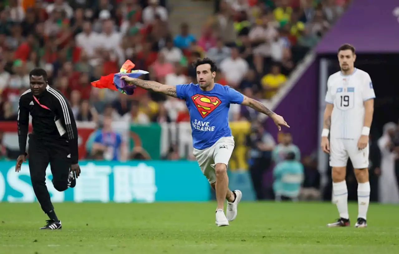 Man invades Portugal v Uruguay pitch wearing 'save Ukraine' t-shirt and holding Pride flag