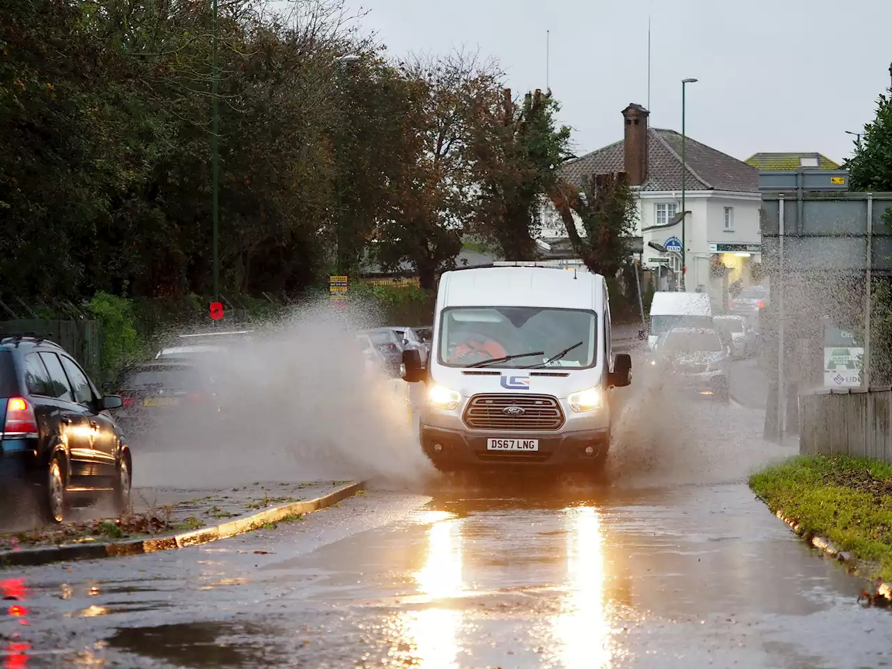 Heavy rain causes train delays and flooded roads, creating chaos for commuters