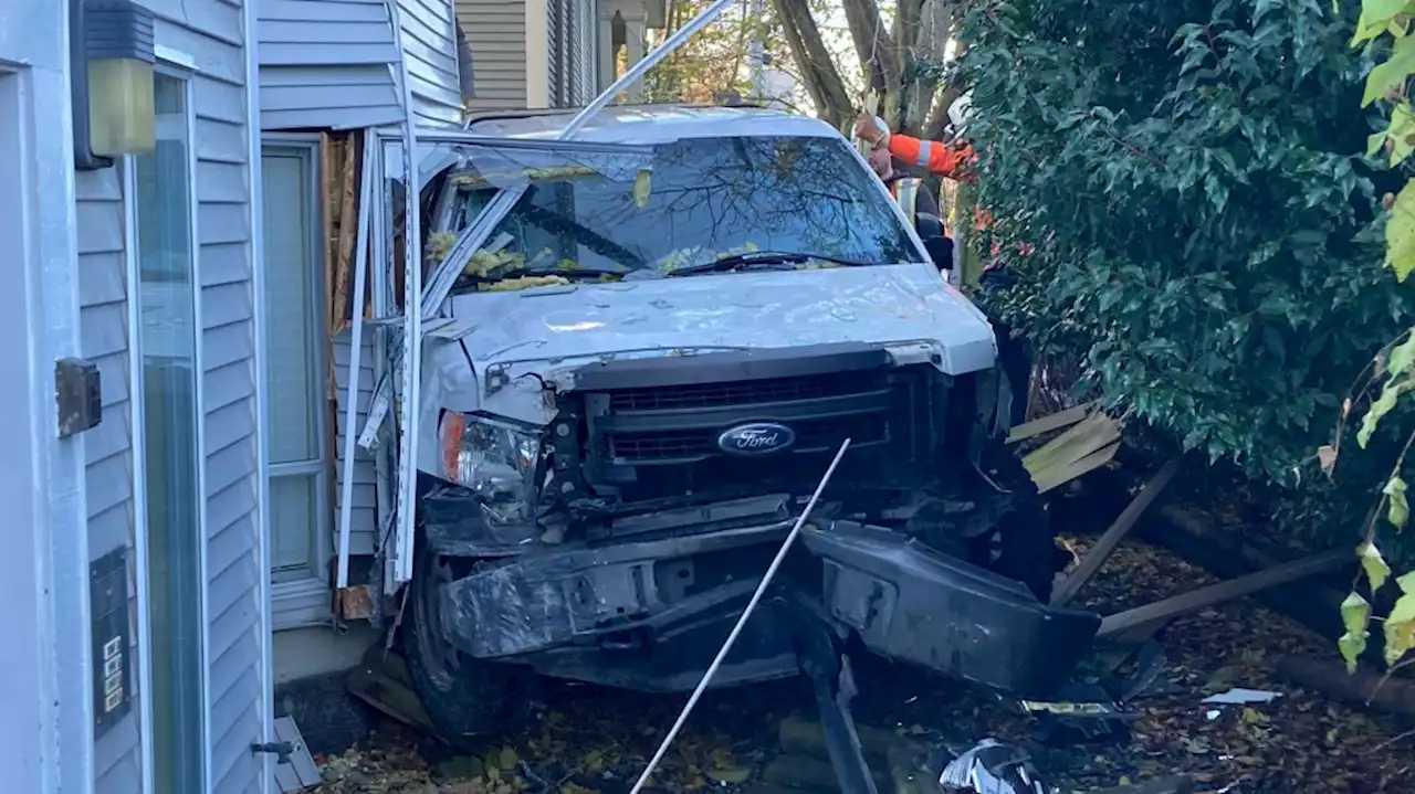 Driver taken to hospital after truck slams into Victoria apartment