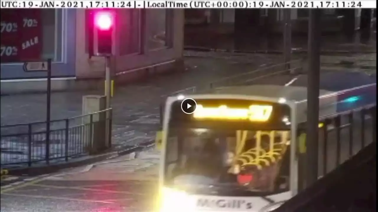 WATCH as bus driver came within inches of knocking down pedestrian after running red light