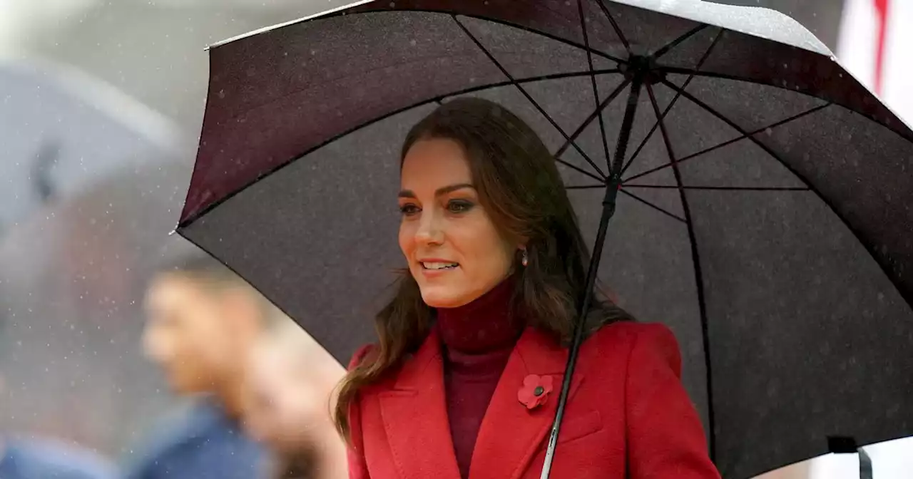 Kate Middleton braves the wet weather in red at England's Rugby League match