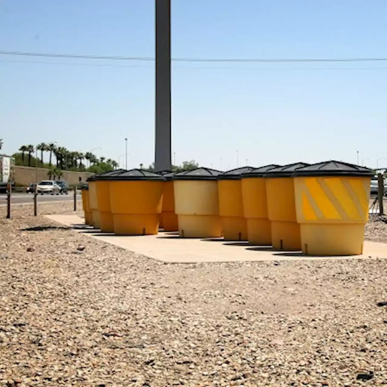 Sand barrel crash cushions designed to take an impact | ADOT