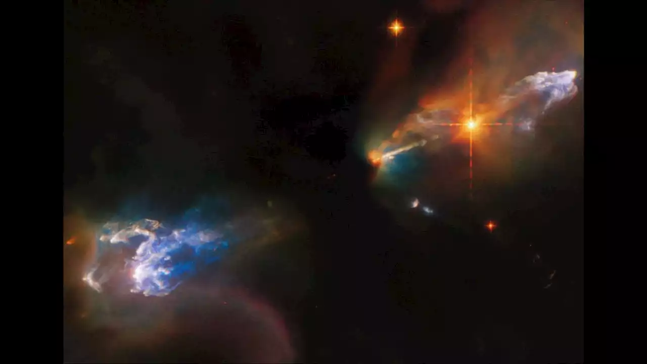 Newborn twin stars blast out jets of rainbow-colored gas in new Hubble image