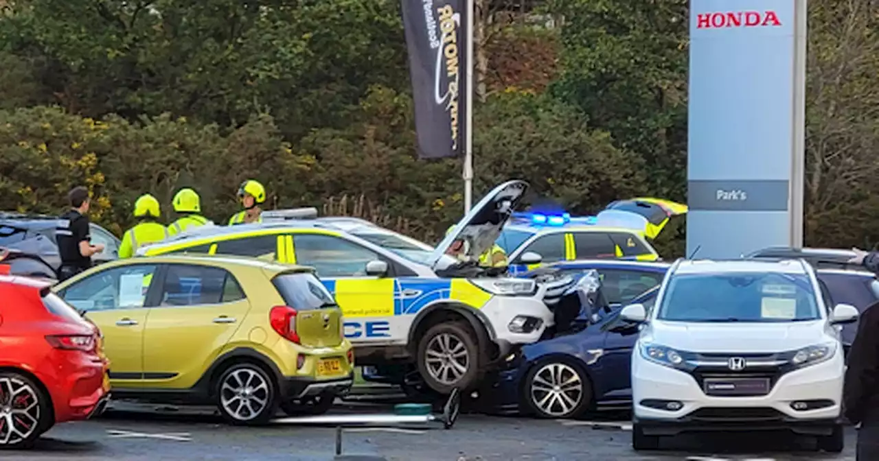 Police car 'loses control' and smashes into two motors outside Scots garage