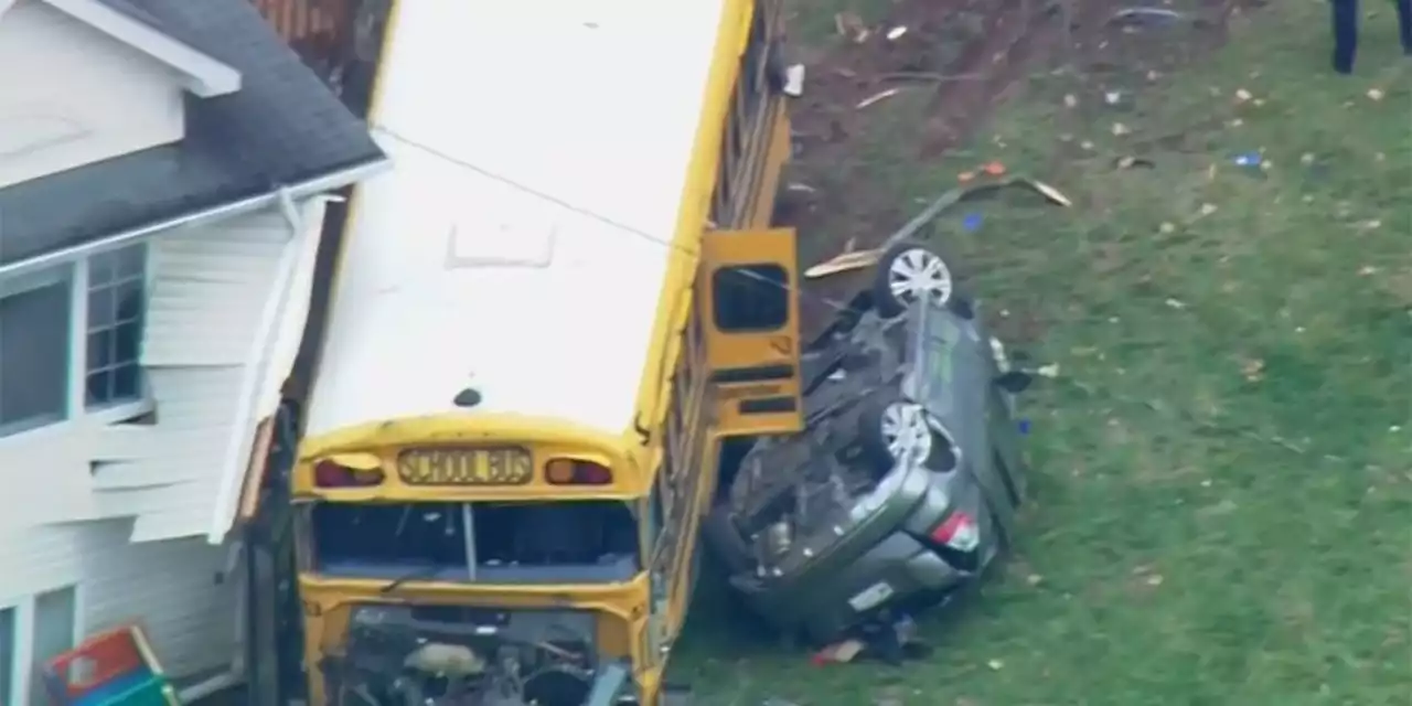 School bus with children aboard crashes into New York home