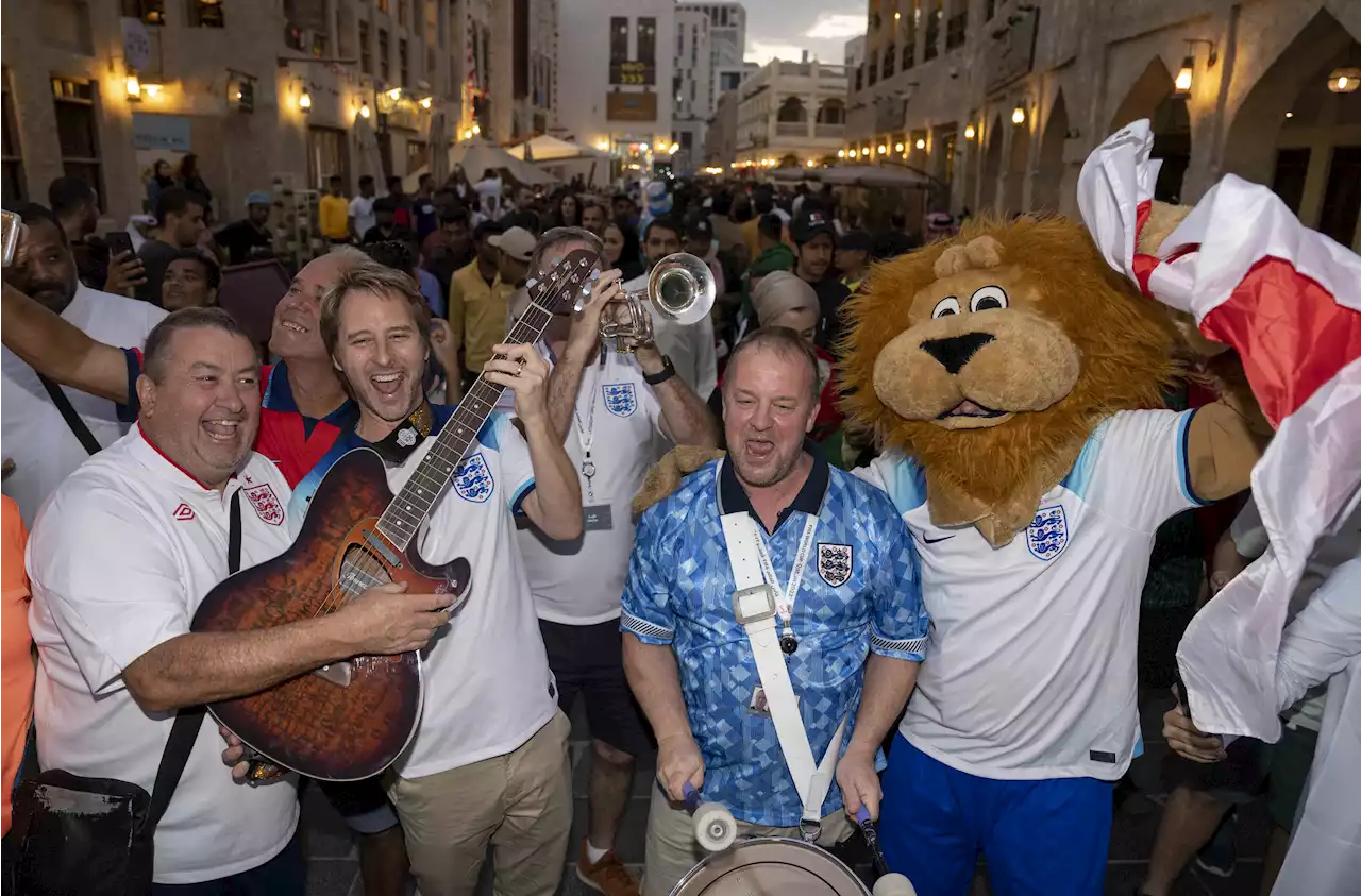 England fans are heralded by a Sun mascot parade through the capital’s souk