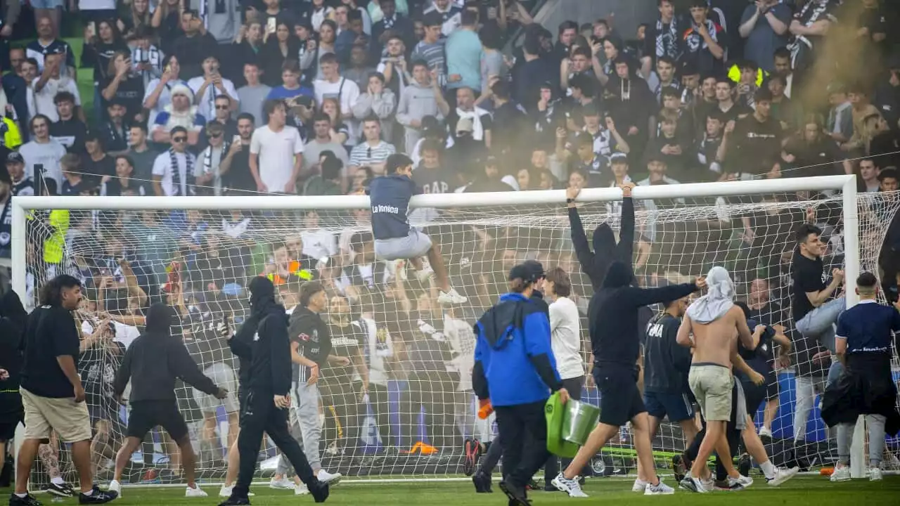 Three men charged over Melbourne A-League pitch invasion