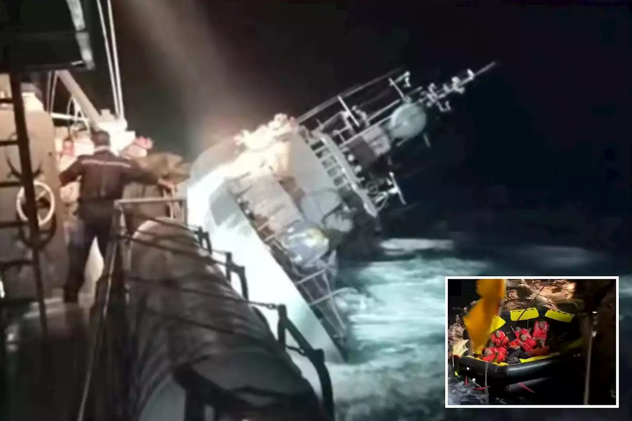 Search for sailors 'in the water' after warship rolls over and sinks in storm