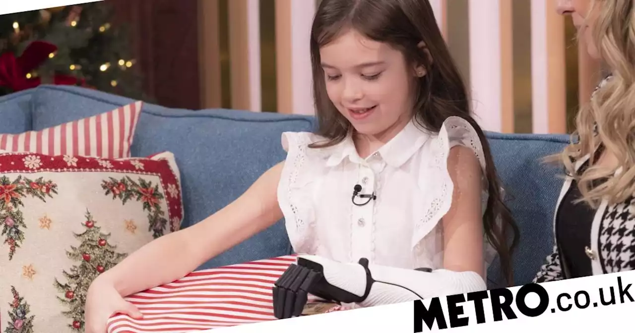 Girl, 7, uses bionic hand to unwrap Christmas present for the first time