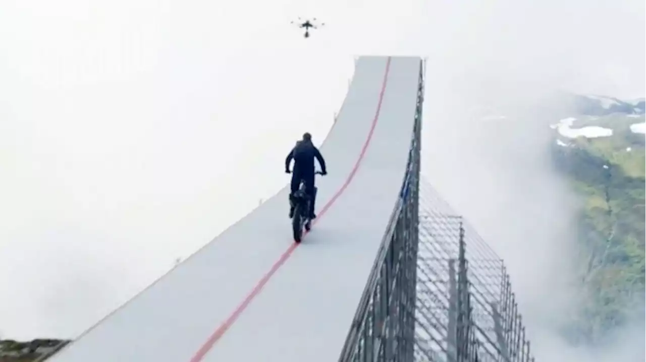 Tom Cruise rides motorcycle off mountain for movie