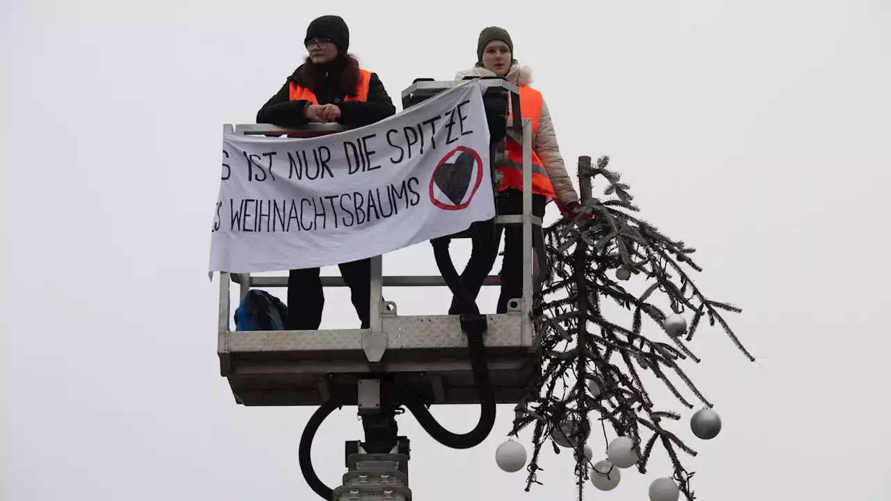 Activists cut off top of huge Christmas tree in climate protest in Berlin