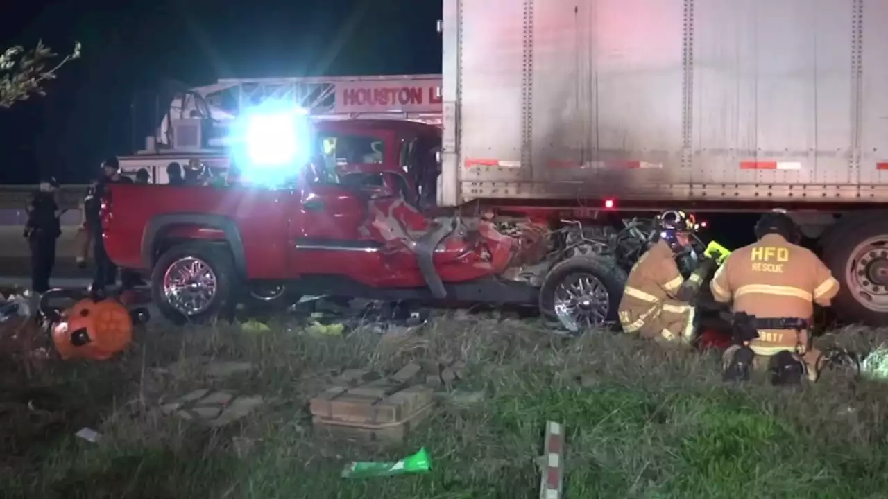 Driver freed after slamming into 18-wheeler, getting trapped several feet under, firefighters say