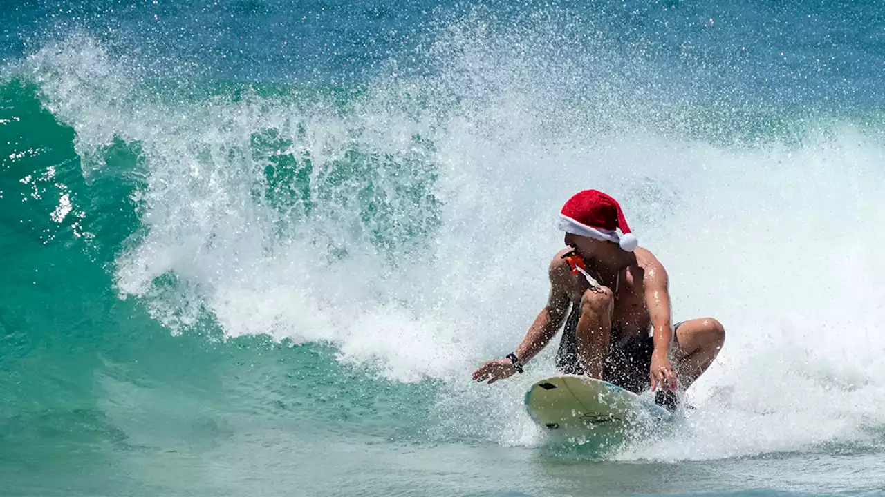 Frigid weather doesn't stop Santas surfing off Florida coast