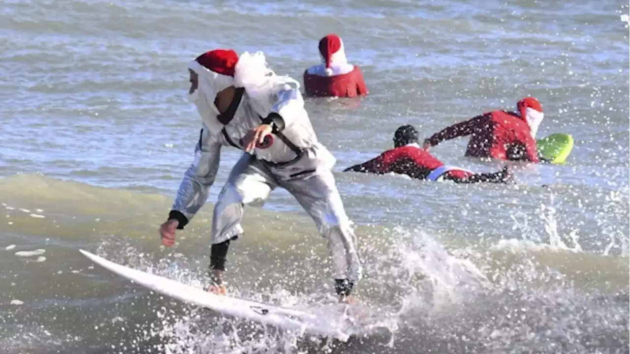 Frigid weather doesn't stop Santas surfing off Florida coast