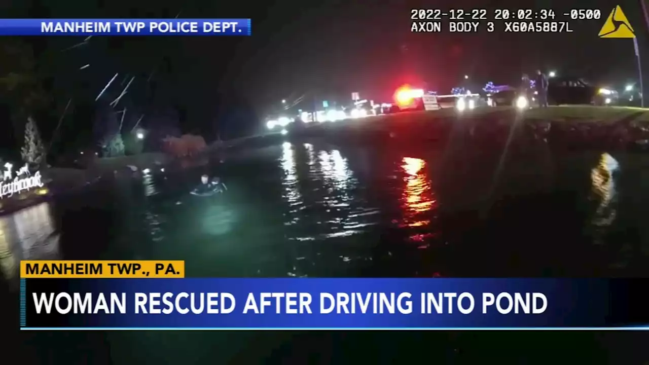 Police bodycam video shows officers rescuing woman from submerged car