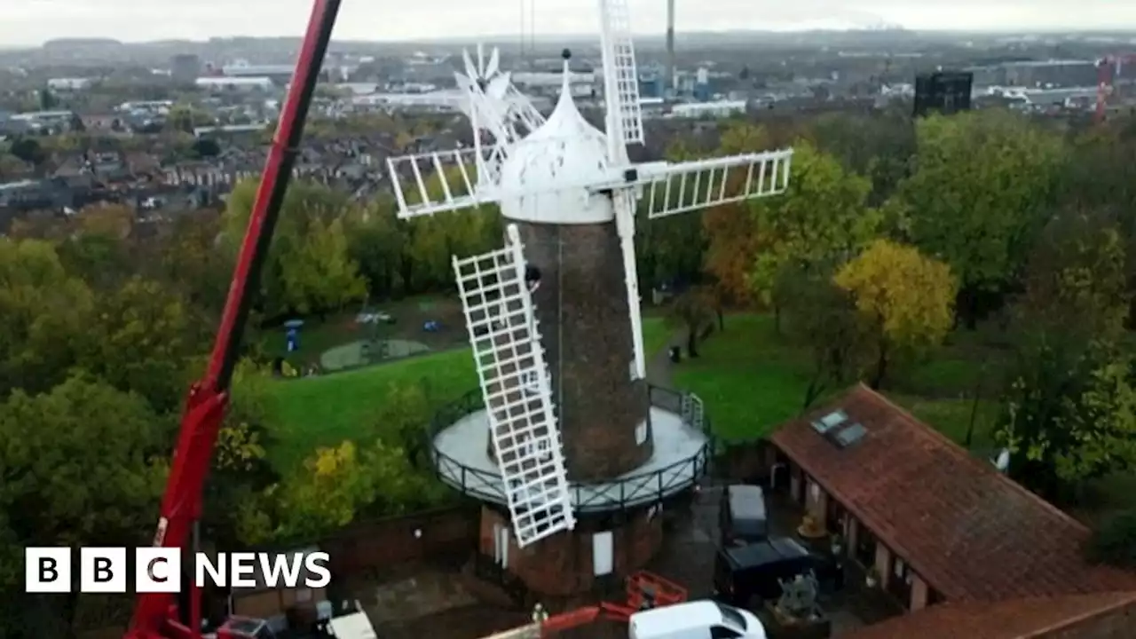 Historical windmill's sails are removed for repairs